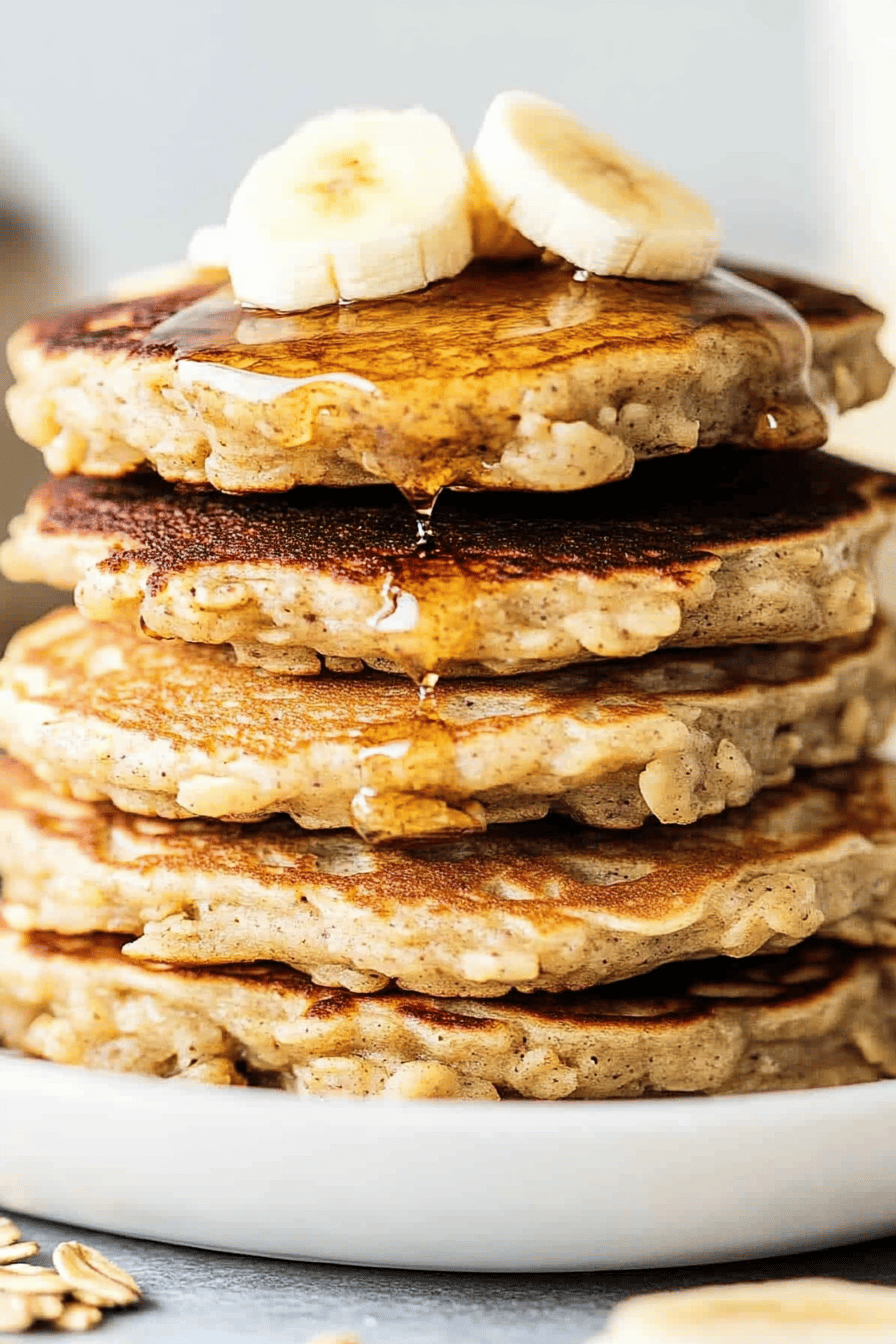 Banana oatmeal pancakes slice on plate showing perfect texture and swirl pattern